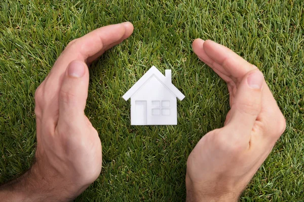 Elevated View Human Hand Protecting House Model Green Grass — Stock Photo, Image