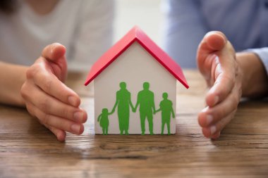 Çift koruma aile Kağıt Kes şunu Elin ve Model üzerinde ahşap Resepsiyon evde