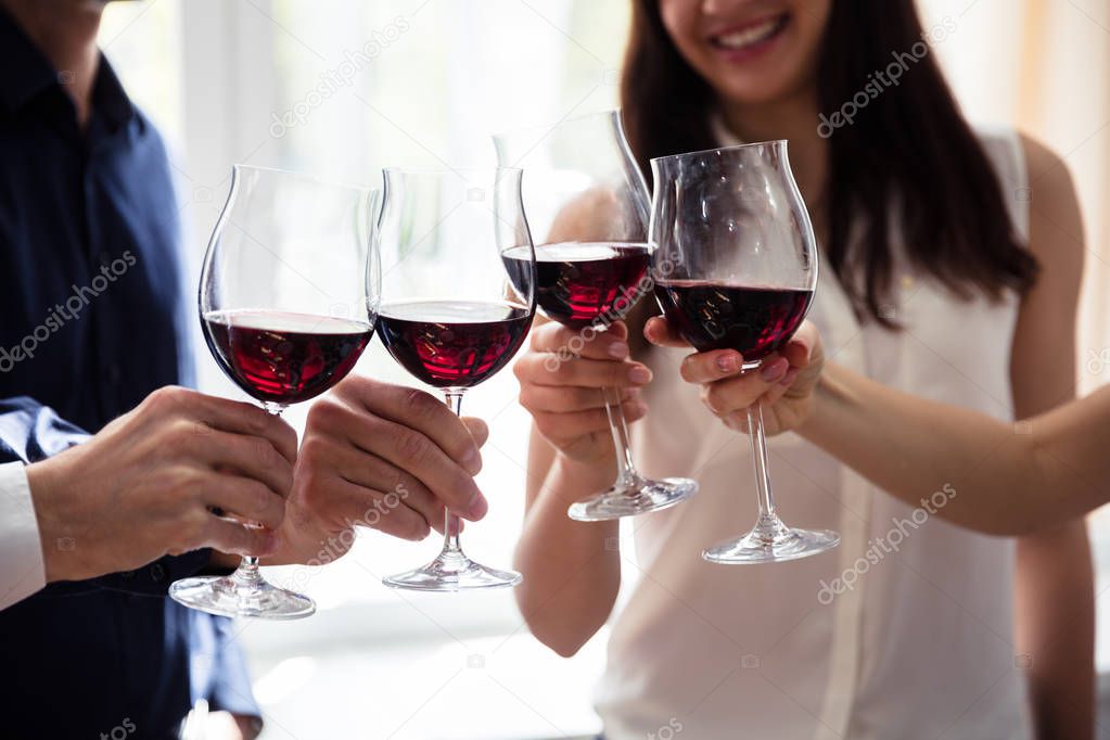 Close-up Of Friends Toasting Wineglasses At Party