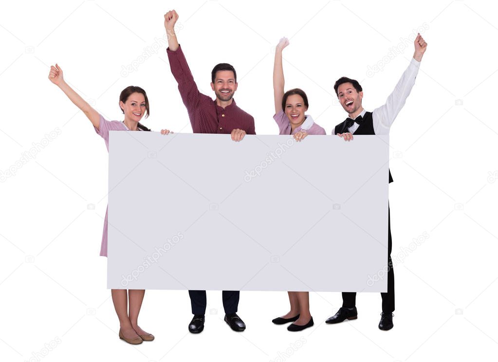 Excited Young Male And Female Staff Holding Billboard Raising Their Arms On White Background