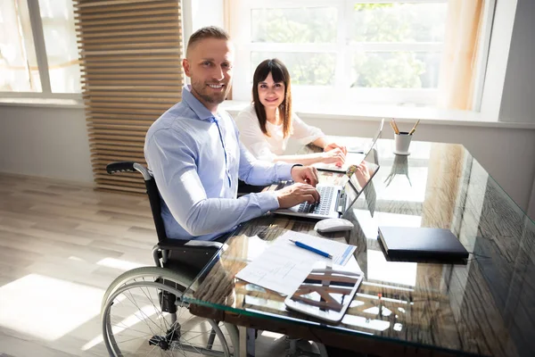 Portrait Smiling Disabled Businessman His Colleague Working Laptop — Stock Photo, Image