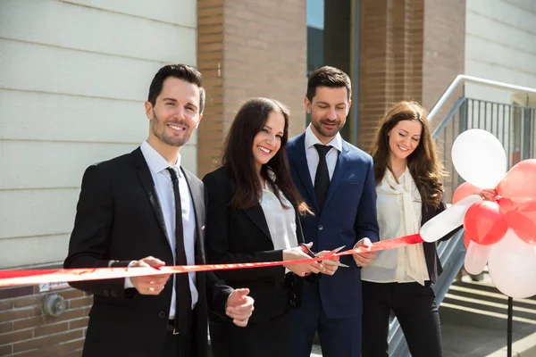Happy Businesspeople Cutting Ribbon Office Building — Stock Photo, Image