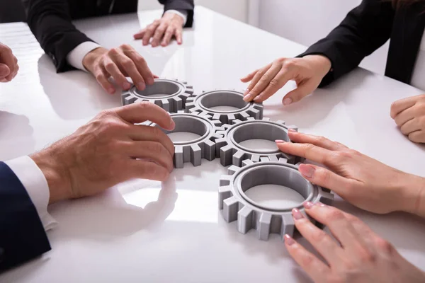 Group Businesspeople Joining Together Gears Table Workplace — Stock Photo, Image