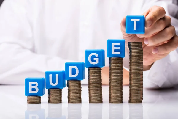 Person Hand Placing Blue Cubic Blocks Budget Word Stacked Coins — Stock Photo, Image