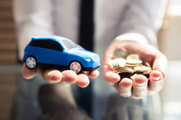 Close Businessperson Hand Holding Small Blue Car Golden Coins — Stock Photo, Image