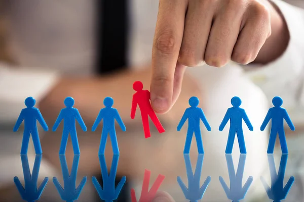 Businessperson Hand Picking Red Human Figures Amongst Blue Figures Row — Stock Photo, Image