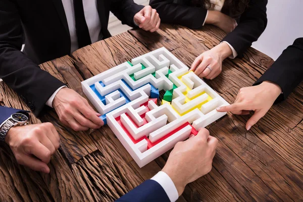 Elevated View Businesspeople Hand Solving Maze Together Wooden Background — Stock Photo, Image