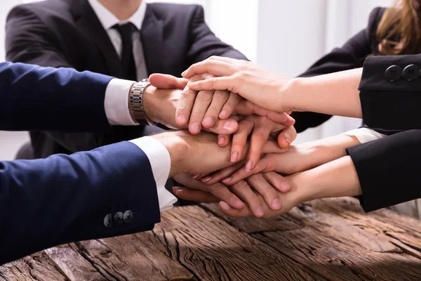 Elevated View Businesspeople Stacking Hands Wooden Desk — Stock Photo, Image