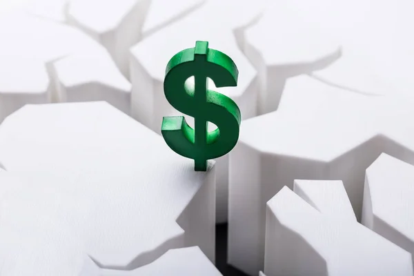 Close-up Of Green Dollar Currency Sign On Damaged White Surface