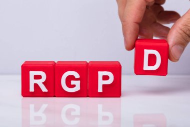 Close-up Of A Human Hand Placing D Letter Red Block To Make Rgpd Word clipart