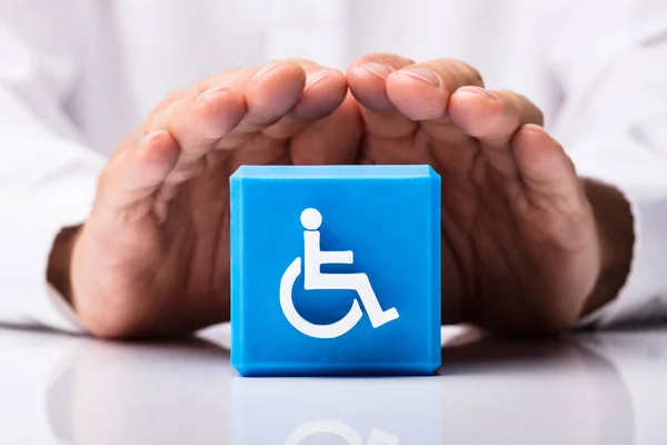 Close Person Hand Protecting Blue Cubic Block Disabled Icon — Stock Photo, Image