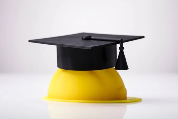 Close Graduation Hat Yellow Hardhat White Background — Stock Photo, Image