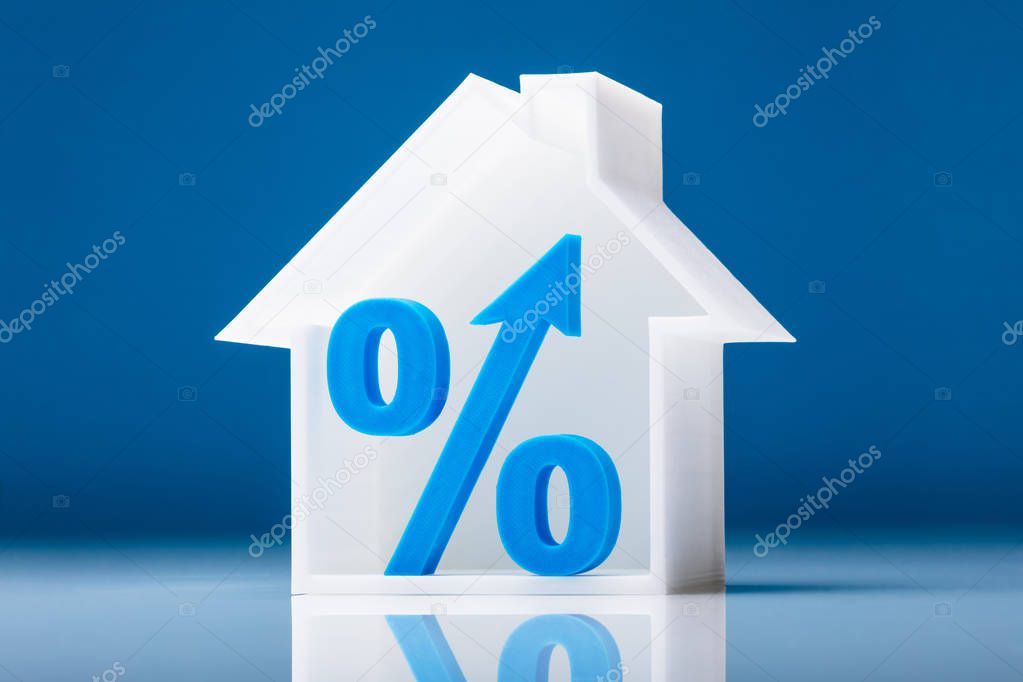 Blue Percentage Symbol Inside House Model On White Background