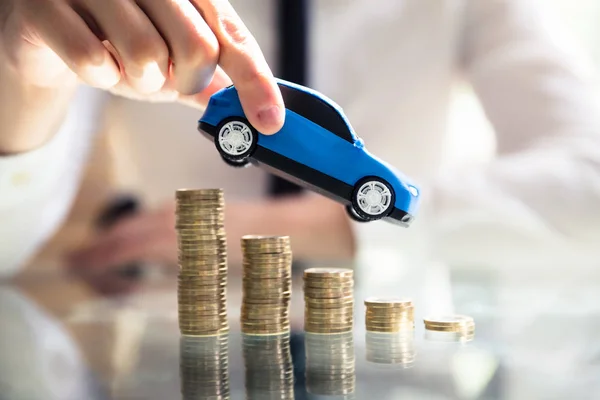 Close Person Hand Flying Car Declining Stacked Coins — Stock Photo, Image