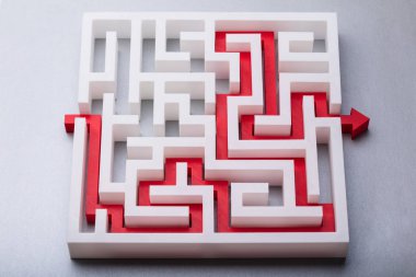 High Angle View Of Red Arrow Showing Path Through Maze clipart
