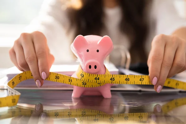 Businesswoman Hand Measuring Piggybank Yellow Measuring Tape Glass Desk — Stock Photo, Image