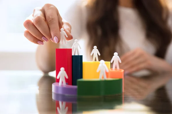 Businesswoman Hand Placing Human Figures Multi Colored Pie Chart Desk — Stock Photo, Image