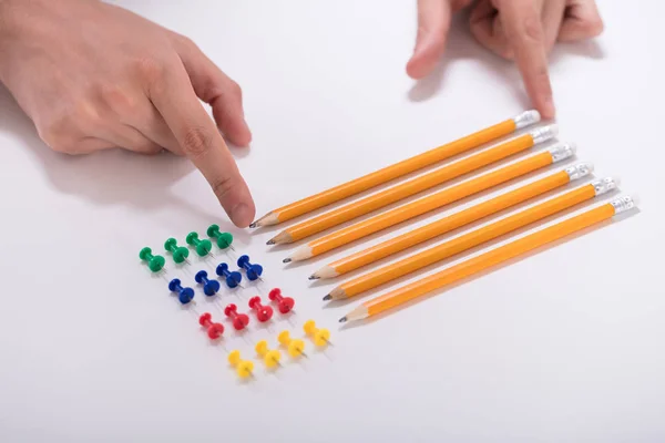 Person Hand Arranging Pencils Multi Colored Pushpins Row White Background — Stock Photo, Image