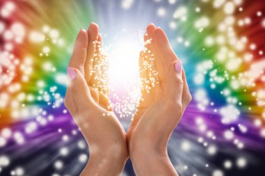 Close-up Of A Woman's Hand Holding Light Against Colorful Background clipart