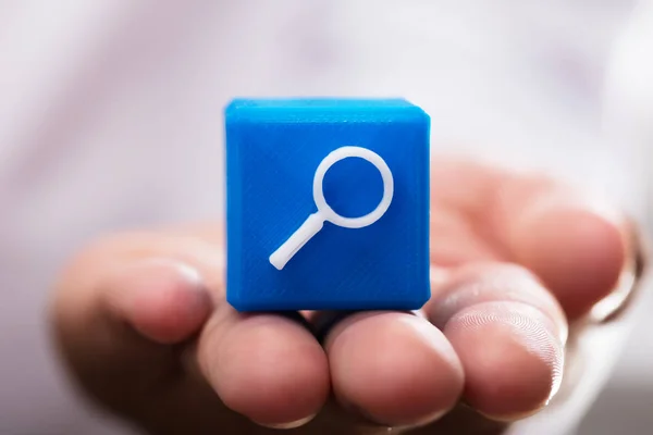 Close Person Hand Holding Blue Magnifying Icon Cubic Block — Stock Photo, Image