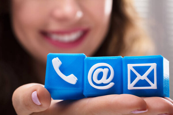 Close-up Of A Woman's Hand Holding Cubic Blocks With Various Communication Options