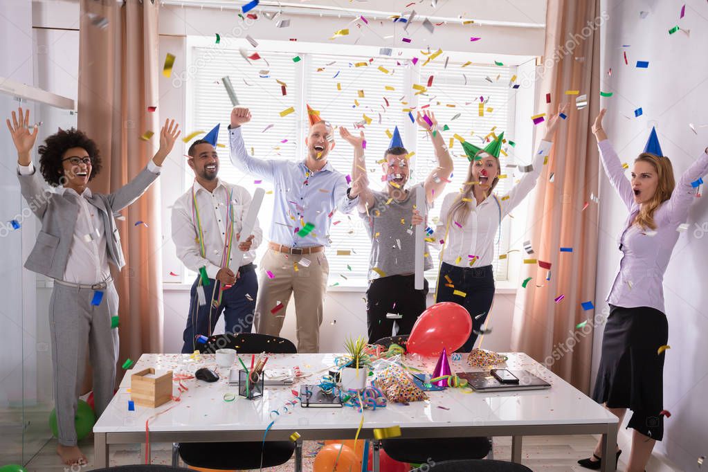 Group Of Young Businesspeople Celebrating New Year Party In Office