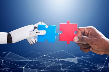 Robot And Human Hand Joining Red And Blue Jigsaw Over The Blue Digital Background clipart