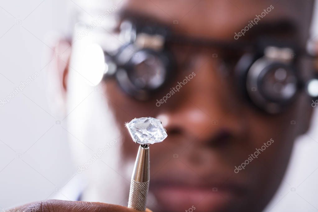 Macro Shot Of A Person Looking At Diamond With Magnifying Loupe
