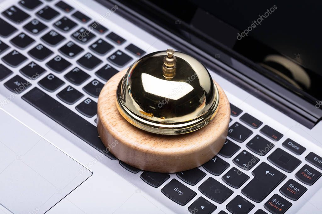 Close-up Of Golden Service Bell On Laptop Keypad