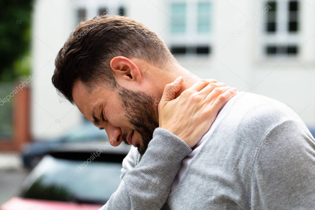 Young Man Having Pain In His Neck