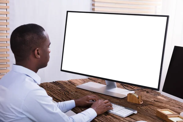 在木桌上用空白白色屏幕的计算机关闭一个商人 — 图库照片