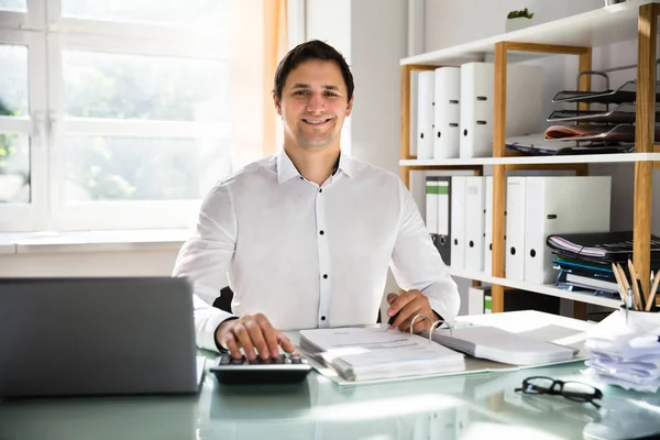 Portrait Happy Young Businessman Calculating Invoice — Stock Photo, Image