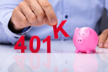A Person Picking K Alphabet From 401k Pension Plan Beside Piggybank clipart