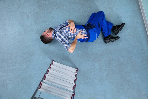 Injured Handyman Lying Floor Falling Ladder — Stock Photo, Image