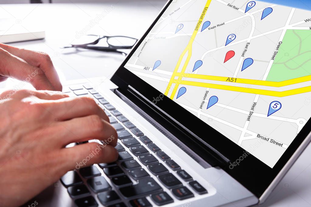 A Person Using Gps Map With Navigation Pointer On Laptop