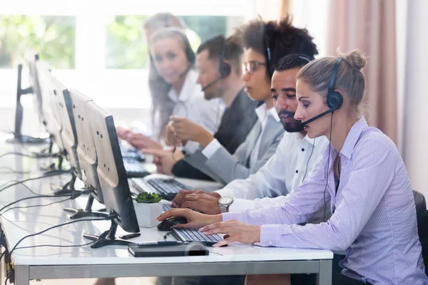 Young Customer Service Executives Using Earphones Working Call Center — Stock Photo, Image