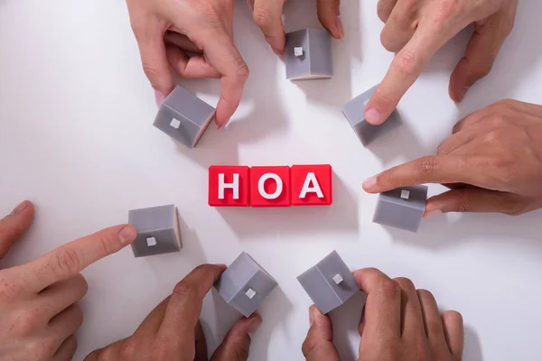 Homeowner Association Blocks Surrounded People Holding House Model White Surface — Stock Photo, Image