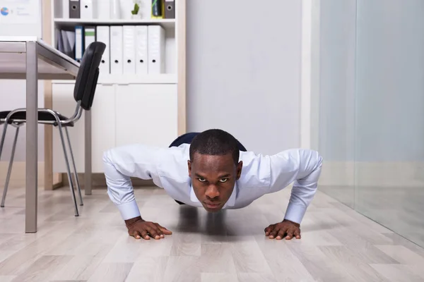 Young African American Man Doing Pushup Front Closed Glass Door — Stock Photo, Image