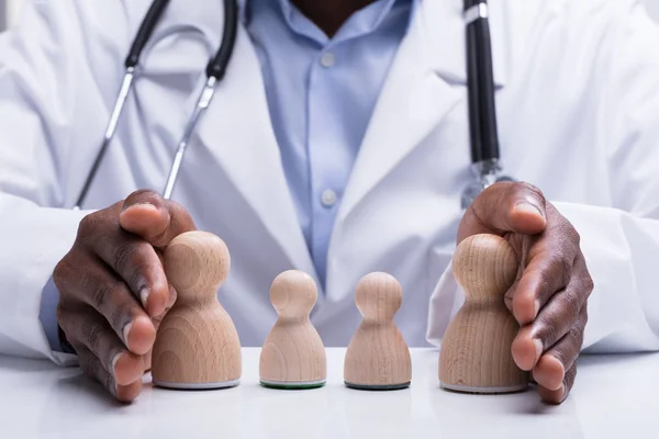 Close Doctor Stethoscope Protecting Wooden Pawn Family His Hand Desk — Stock Photo, Image