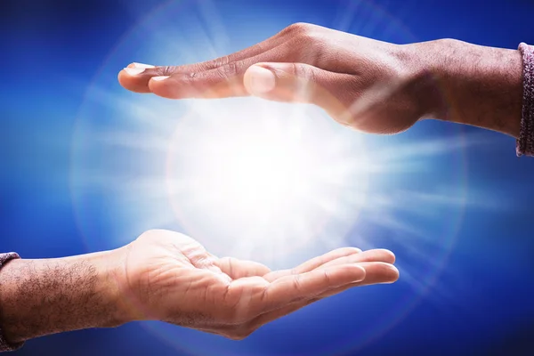 Male Hand Collecting Glowing Sunlight Flare Blue Background — Stock Photo, Image