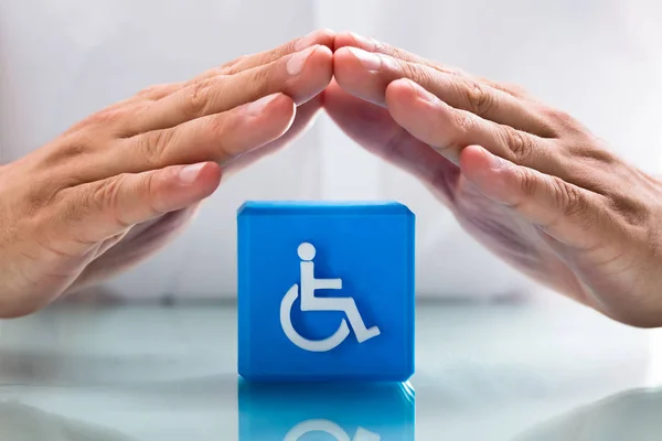Close Human Hand Protecting Blue Cubic Block Handicap Icon — Stock Photo, Image
