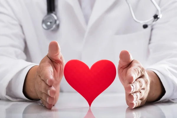 Doctor Hand Protecting Red Heart Desk — Stock Photo, Image