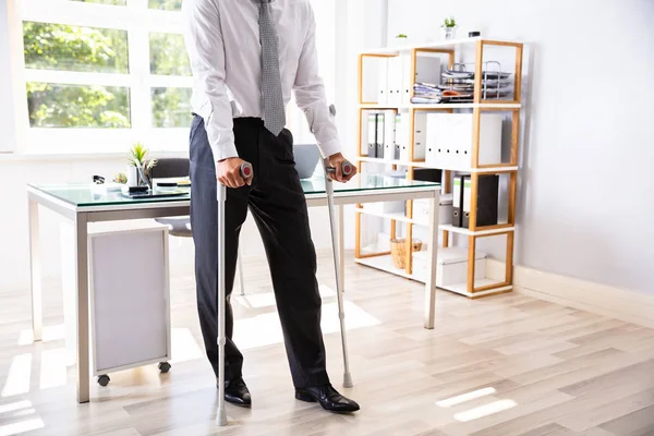 Businessman Dinonaktifkan Dengan Crutches Berdiri Kantor — Stok Foto