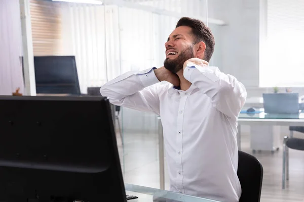 Joven Empresario Sintiendo Dolor Cuello Lugar Trabajo —  Fotos de Stock