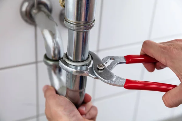 Close Plumber Hand Repairing Sink Adjustable Wrench — Stock Photo, Image