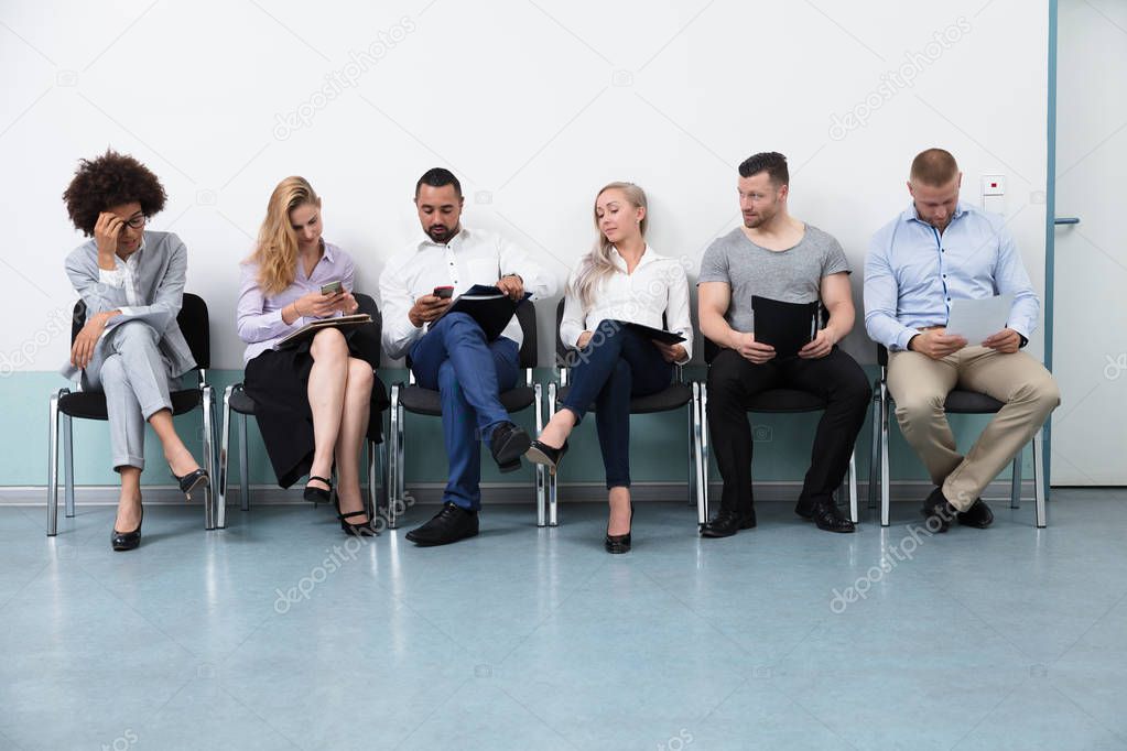 Candidates Sitting On Chair Waiting For An Interview