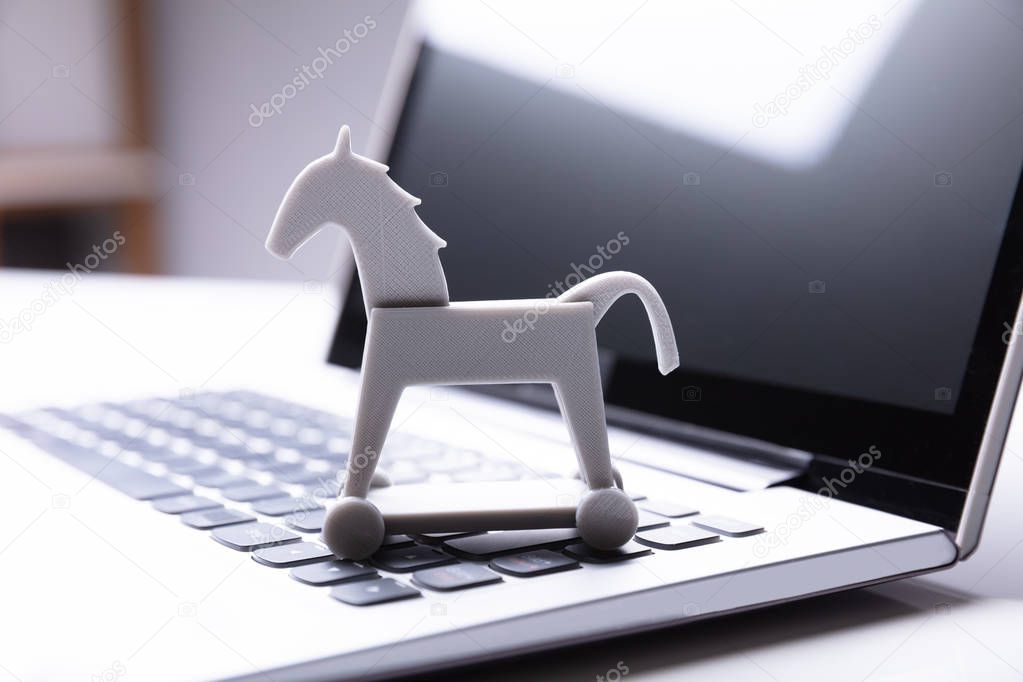 Close-up Of Trojan Horse Icon On Laptop Keypad