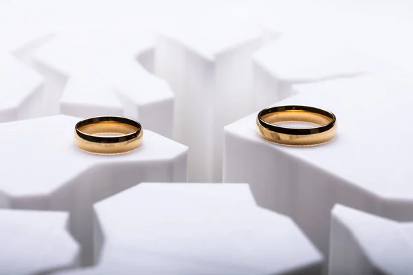两个分开的结婚戒指在破裂的表面 — 图库照片