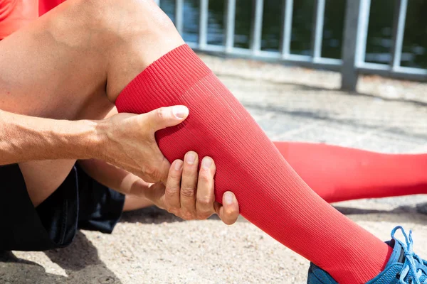 Close-up Of A Male Runner Suffering From Pain In Calf Muscle — Stock Image Close Male Runner Suffering Pain Calf Muscle Royalty Free Stock Photos