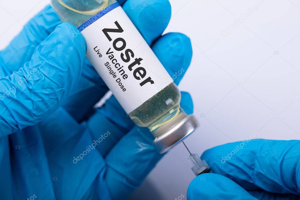 Doctor's Hand Wearing Blue Glove Filling Zoster Vaccine Syringe